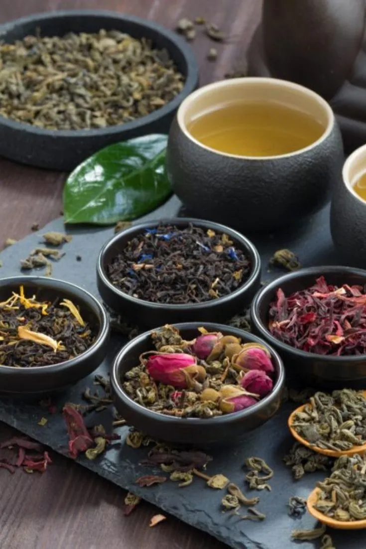 Dried herbs and measuring tools on dark surface